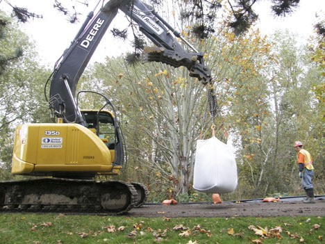 Crews continue to bolster the levees along the Green River with supersacks and other barriers.