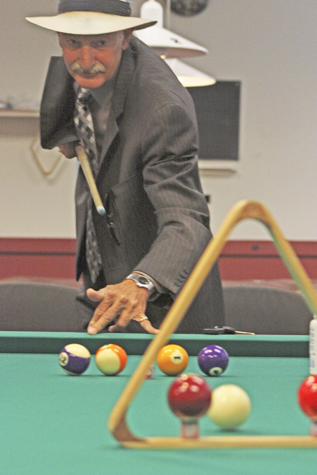 Richard “Rich the Hat” Geiler performs one of his trick shots.