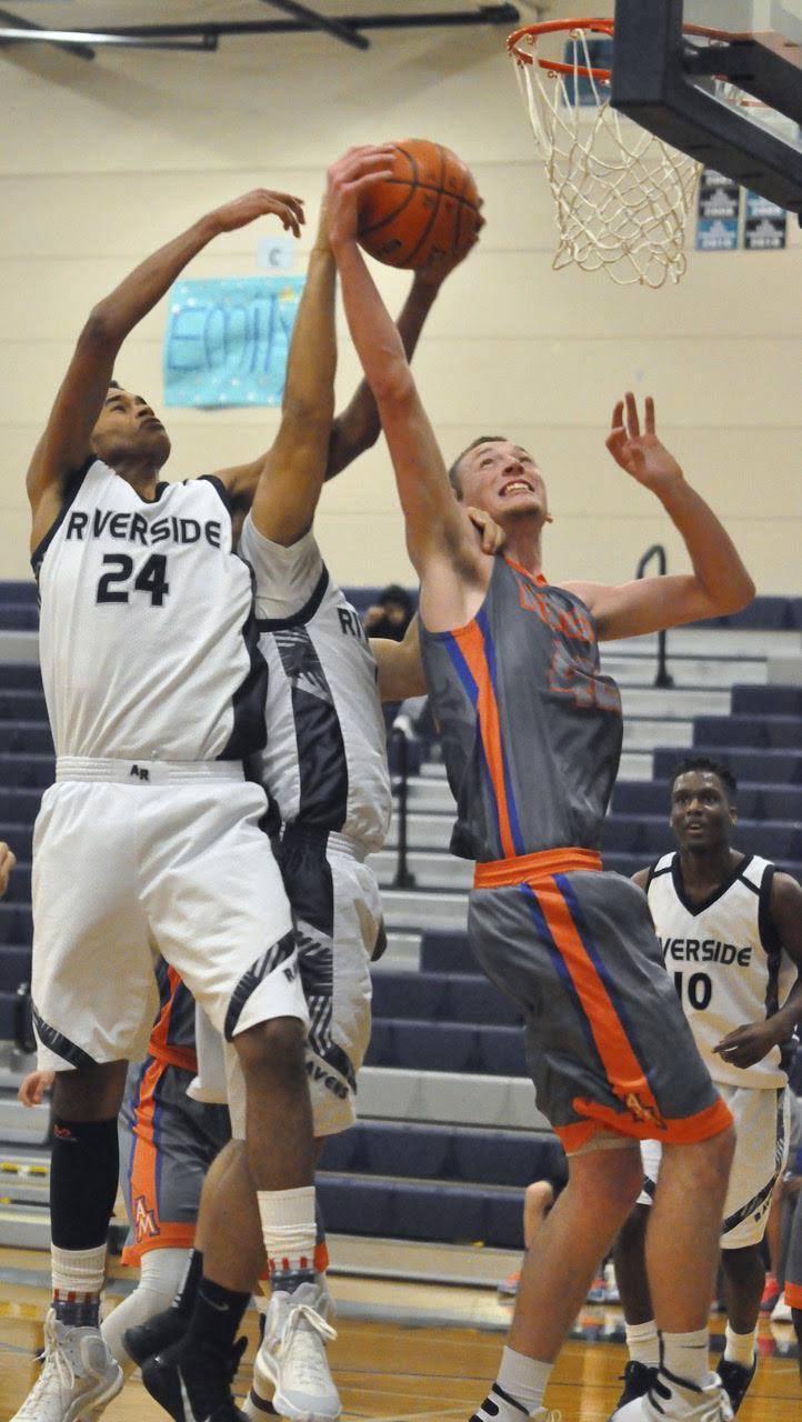 Auburn Riverside’s Quintin Bethea and Auburn Mountainview’s Tristan Miguel battle for the ball during the Lions’ 48-41 win Tuesday in a South Puget Sound League 3A boys basketball game. Bethea scored a game-high 26 points for the Ravens.