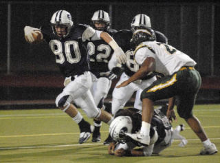 Auburn Riverside’s Dalton Thomas scambers for some extra yardage on a punt return. Thomas finished with a game-high 111 all-purpose yards.