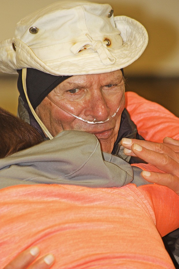 Auburn's Don Stevenson hugs a friend during his 80th birthday party Monday. The marathon walker plans to cover 1