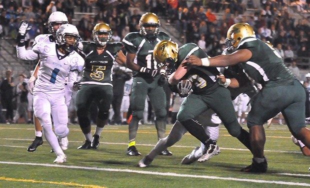 Auburn's Dillon O'Grady powers his way to the end zone in the first half against Auburn Riverside on Friday night.