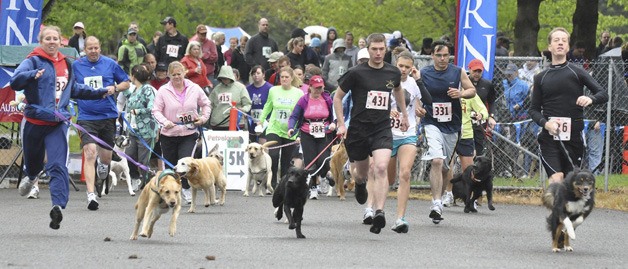 Men and women and their beloved pet canines dart at the start of the Petpalooza’s 3K/5K Dog Trot last Saturday at Game Farm Park. The run was part of the all-day pet festival