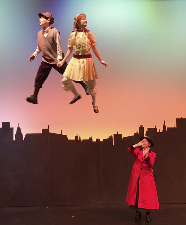 Jane and Michael Banks (Olivia Thomas and Sawyer Englund) soar above Mary Poppins (Windy Autumn Foster) during rehearsal for the musical production at Green River College.