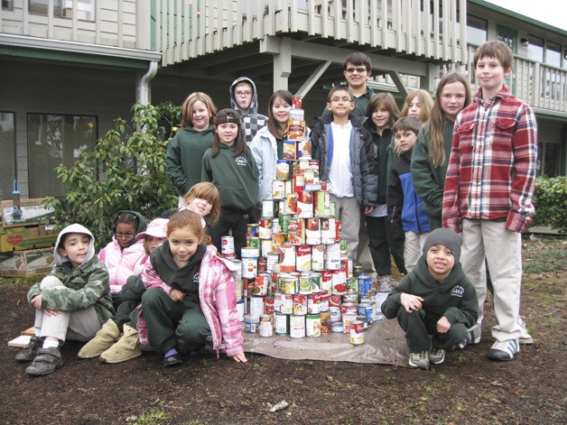 Students at Auburn’s Green River Montessori School were busy making a food pyramid of donated cans destined for the Auburn Food Bank last Friday morning. What began as a food drive competition among classrooms grew into a school-wide campaign that accumulated 374 packages or containers of food. “We wanted the kids to experience collecting food and giving to the needy