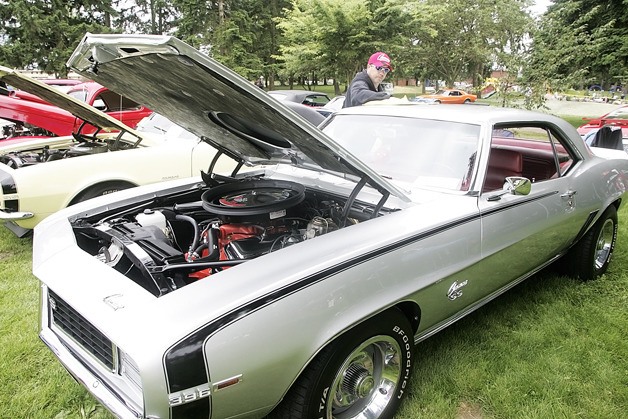 Garry Delisle polishes his 1969 Camaro SSRS 396 during the “Cruise to the Park” Car show at Les Gove Park on June 25.
