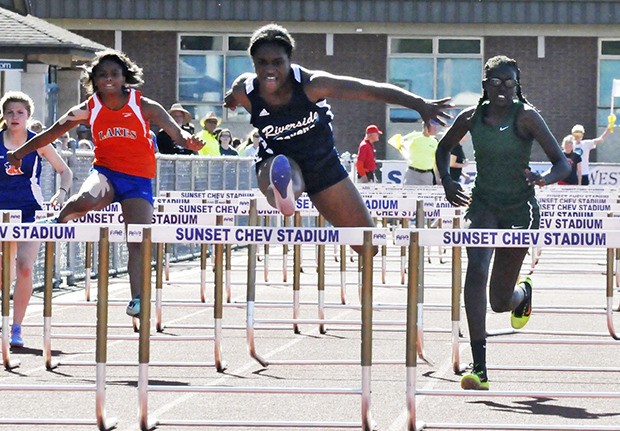 Auburn Riverside's McKenzi Williams charges to victory in the 100-meter hurdles. Her time was 15.25.