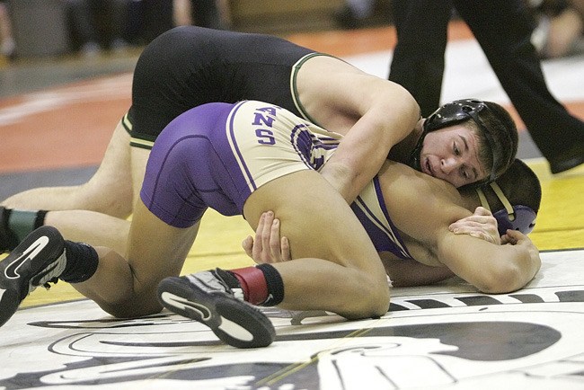 Auburn grappler Josh Tate tangles with Sumner’s A.J. Atoigue during the 152-pound consolation matches at this past week’s All-SPSL Tourney at Auburn High School.