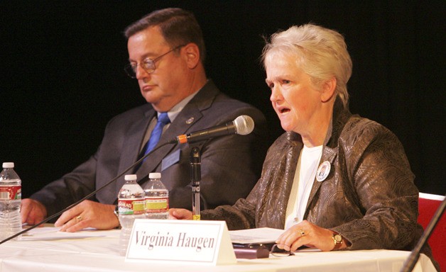 Incumbent Virginia Haugen answers a question while challenger John Hayes Holman prepares to respond during the recent City Council candidates debate.