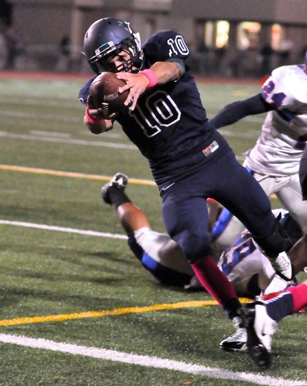 Senior quarterback Kevin Thomson scores on the ground against Kent-Meridian.