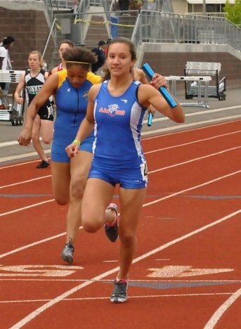Auburn Mountainview junior Erika Lombardo crosses the finish line during the 4x100 girls relay at the West Central District III 3A meet.