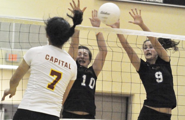 Auburn Mountainview's Sam Odren (10) and Stephanie Sinclair apply the block in front of Capital hitter Aria Goodman during district play. The Lions open state 3A tournament play Friday in Kennewick.