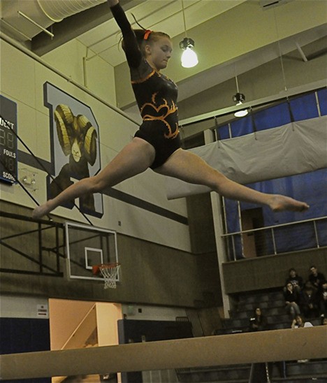 Sarah Fiskdal performs a routine on the beam at a meet at Rogers High School in Puyallup.