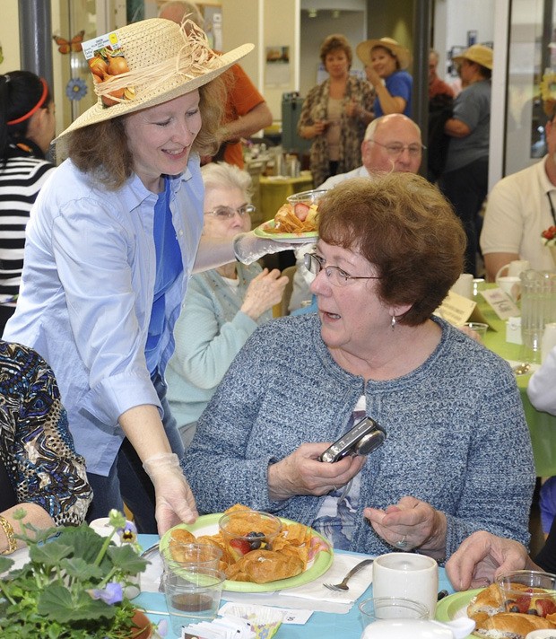 Janet Koch serves lunch to Maureen High during a special gathering honoring volunteers at the Auburn Senior Activity Center.