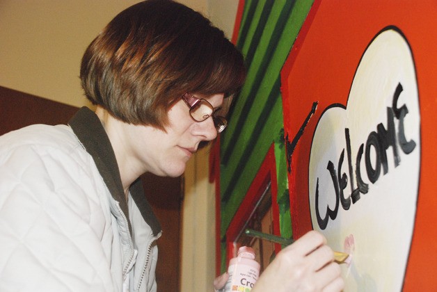 Volunteer Diane Gamlem works on the final touches  of a mural at the Jennifer Beach Foundation offices near Grace Community Church.