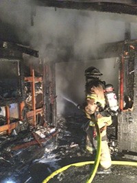 Firefighters mop up what was a garage fire to the 1100 block of 26th Street Southeast in Auburn early Monday morning.