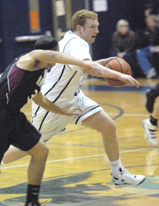 Raven guard Mitch Hagerty drives against the Kentlake Falcons this past week. Hagerty helped lead the team to a 90-81 win with 31 points and 10 rebounds.