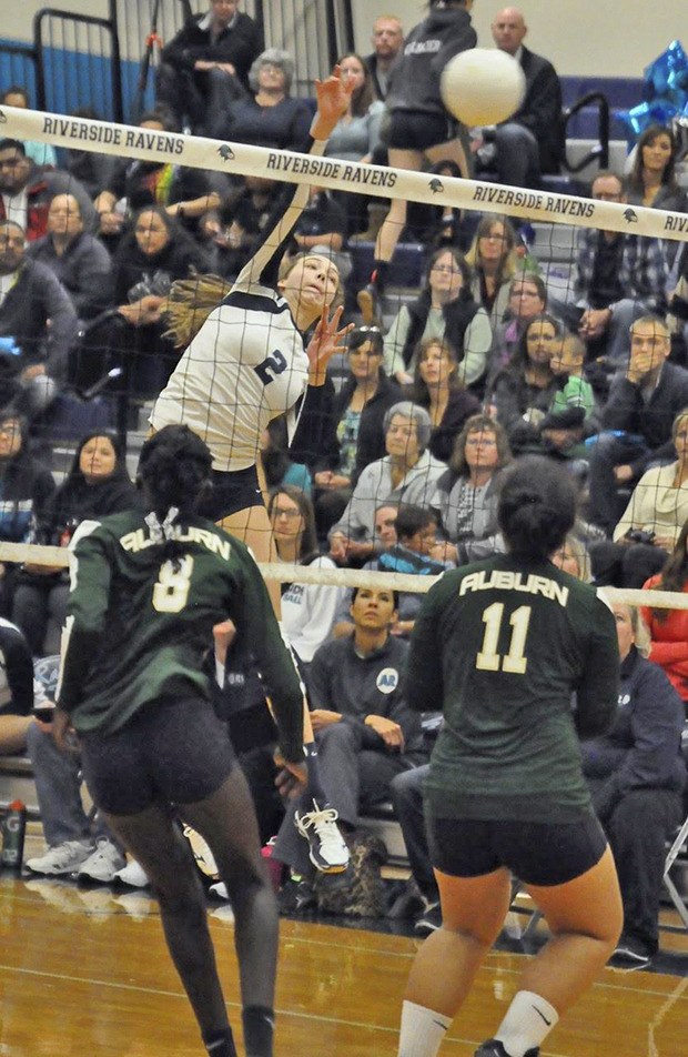 Auburn Riverside's Calley Heilborn spikes the ball over against Auburn during SPSL 3A play Wednesday night.