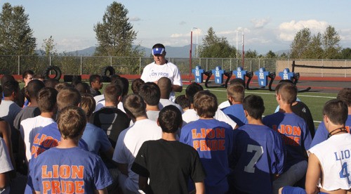 First year Auburn Mountainview head football coach Craig Spence talks to the squad before practice.