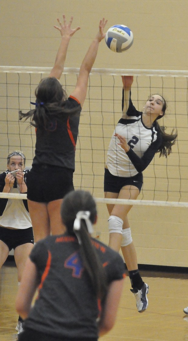 Auburn Riverside's Calley Heilborn drills a return shot against Auburn Mountainview on Saturday. The Ravens prevailed over their rivals in five games to finish third in the district tournament and earn a return trip to the state Class 3A tournament.