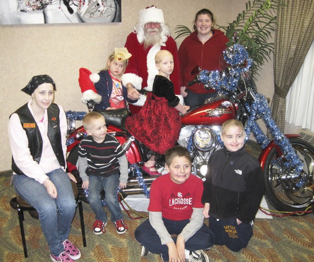 Families gathered at the Auburn Best Western Peppertree Inn for the South Sound Chapter of Bikers Fighting Cancer Christmas gift giveaway.