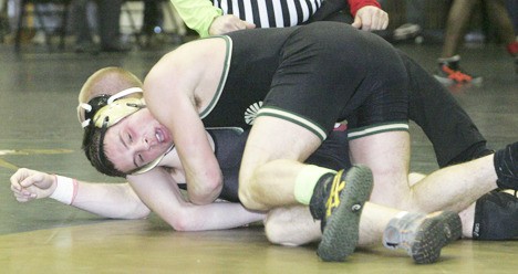 Auburn's Dylan Rutledge rides Snohomish's Mark Morrill for the 171-pound regional title. Rutledge prevailed