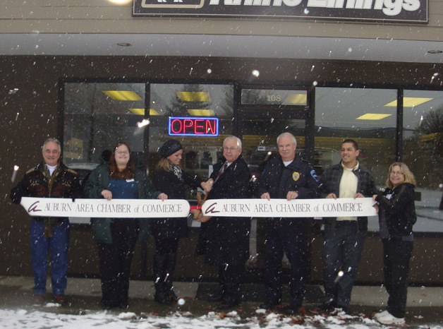 Mayor Pete Lewis joins Rhino Linings owner Kaelen Schaefer-Kranz and Auburn Area Chamber of Commerce members at a ribbon-cutting ceremony.