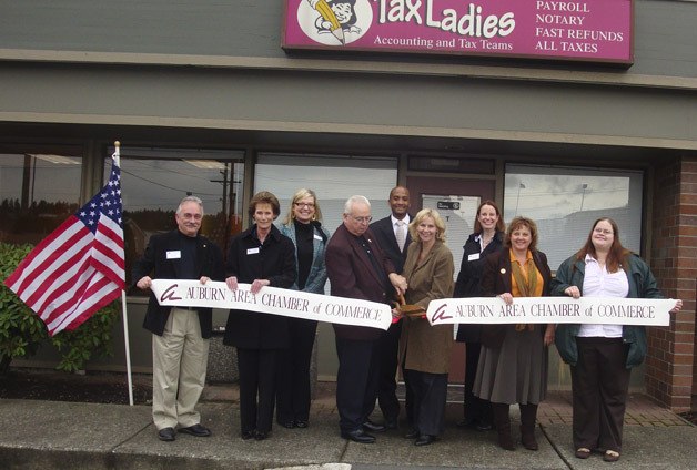 Mayor Pete Lewis joins the Tax Ladies' Loraine Hayden and Sean Schaffer and Auburn Area Chamber of Commerce members at a ribbon-cutting ceremony.