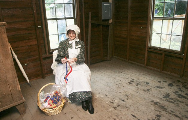 Hilda Meryhew braids pieces of cloth together in the weave house during the grand opening of the Mary Olson Farm last Saturday.