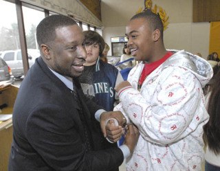 Cascade Middle School principal Isaiah Johnson shares a laugh about an upcoming staff versus students basketball game with D’Andre Preston