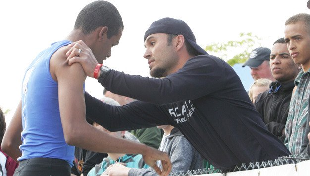 Kent-Meridian's Derrick Daigre gets consoled by track coach Ernie Ammons after taking second in the 800 meters last May during the Class 4A state championship meet at Mount Tahoma High School in Tacoma.