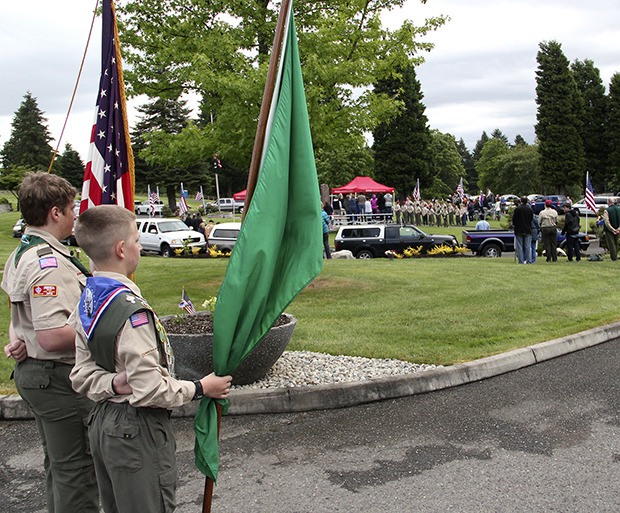 Boy Scout Troop 401 flag bearers Guy Adamo and Conner Whitlock wait for their fellow scouts during Auburn’s Memorial Day remembrance ceremony Monday at Mountain View Cemetery.