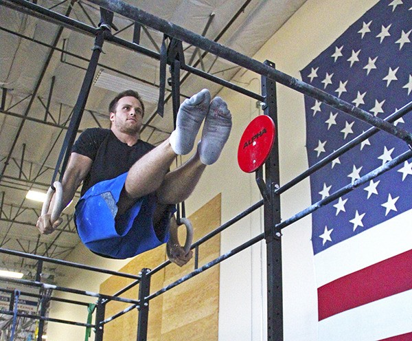 Kevin Simons works out on the rings at Alpha Strength and Conditioning.