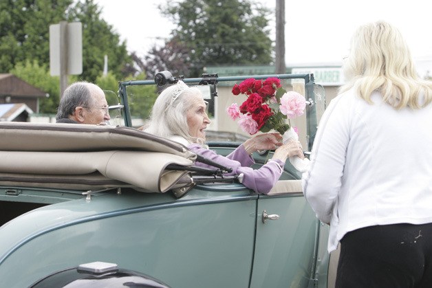 Pioneer Queen Vickie Vallier receives some roses along the parade route during last Saturday's Algona Days festival.