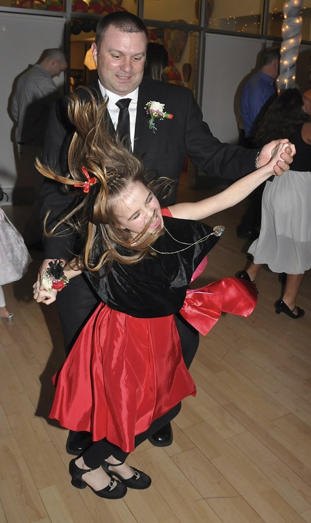 Derek Martinson dances with his daughter
