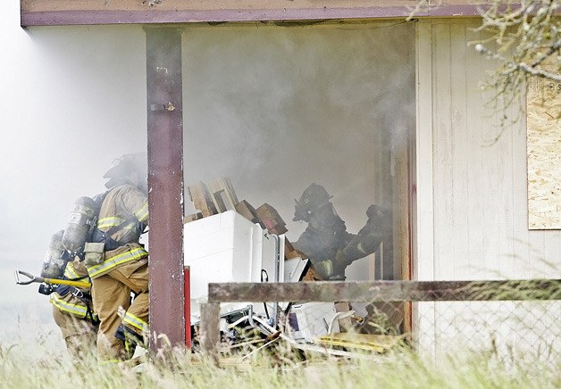 Valley Regional Fire Authority firefighters line up to breach the front door during recent live fire training at 3rd Avenue Southeast