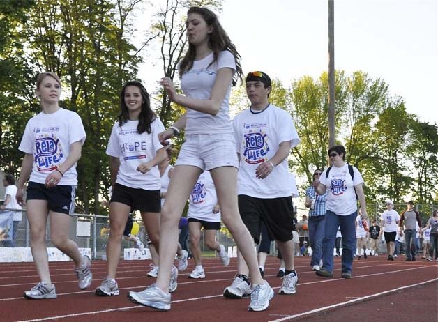 Walkers take to the oval at Auburn Memorial Stadium during last year's relay. The event is one of the area's largest fundraising efforts for the American Cancer Society.