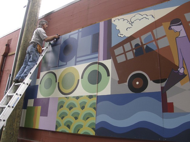 City of Auburn Building Maintenance Technician Tony Chavez assembles the 40-foot-long Auburn Avenue Theater mural last week.