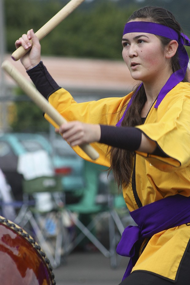 Sera McKinney performs with the Okinawa Kenjin-Kai Taiko group during the Bon Odori Festival at the White River Buddhist Temple last Saturday. Hundreds of people took in Obon dancing