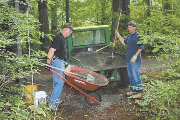 Ken Crabtree and Charles Fowler loaded gravel to place in some post holes.