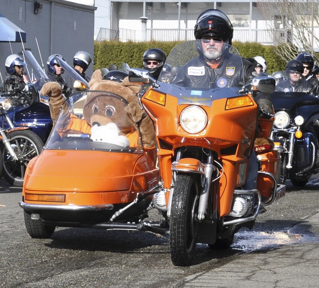 Daniel Snodgrass of the South King County Chapter of Alky Angels escorts Teddy Bear the mascot and a stuffed bear to Auburn Regional.