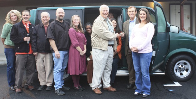 Councilman Pete von Reichbauer and AYR Executive Director Jim Blanchard exchange keys to the retired van alongside fellow AYR employees.