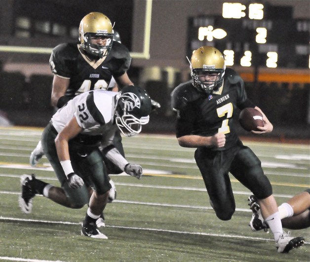 Tarin MacDonald runs for daylight against Edmonds Woodway in Auburn's first-round playoff win. The Trojans return home tonight for a quarterfinal matchup against Curtis.