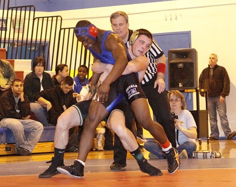 Auburn's Dylan Rutledge manhandles Kent-Meridian's Luke Barzie in the 171-pound weight class at the South Puget Sound League 4A North sub-regionals. Rutledge captured the title with a pin of Barzie at the 3-minute