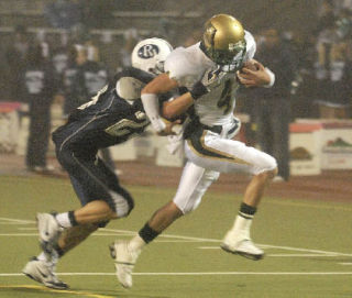 Auburn quarterback Carlo Lavoie is dragged down inside the 5-yard line by Auburn Riverside’s Max Thomas.