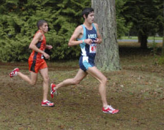 Julian-Blake Cowan is shadowed by Central Kitsap’s Shane Moskowitz at the Westside Classic District meet.