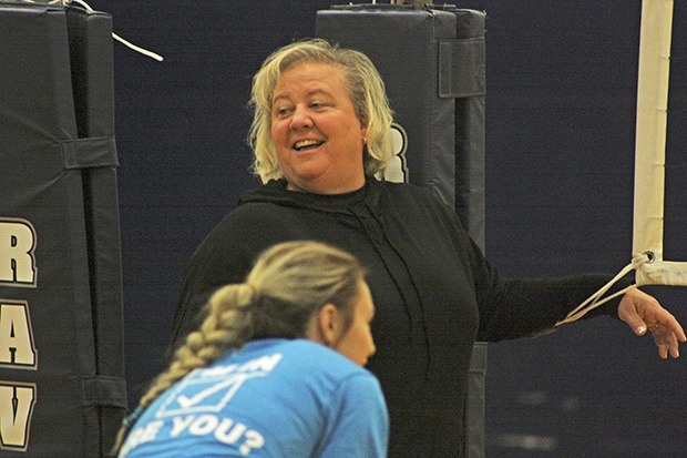 Coach Chris Leverenz shares a light moment with her players during practice in the Auburn Riverside High School gymnasium. Leverenz