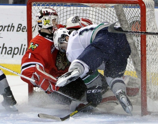 Thunderbirds forward Riley Sheen crashes into Winterhawks goalie Brendan Burke.