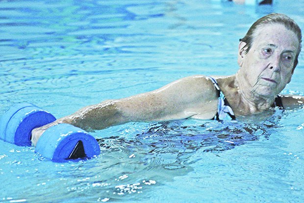 Creating her own wake: Adrienne Rockwell pulls a resistance weight as she leads her deepwater aerobic class at the Auburn Valley YMCA. Rockwell is a rock at the Y