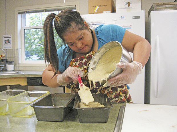 Recipe for learning: Maria prepares banana bread batter to be baked in the TAP building’s kitchen.